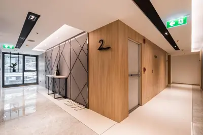 a hallway in a building with a door in the middle at Destiny63 Ekamai Apartment in Bangkok