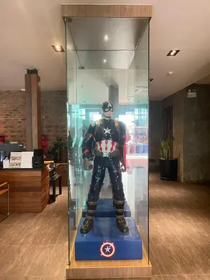 a superhero mannequin in a glass display case at Loft122 Hotel in Ban Zong Katiam