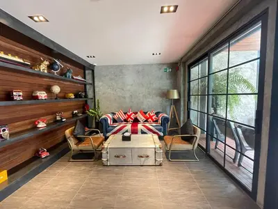 a living room with a couch and chairs and a table at Loft122 Hotel in Ban Zong Katiam