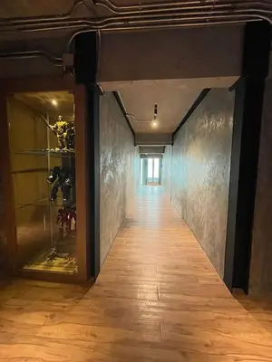 a hallway in a building with a wooden floor at Loft122 Hotel in Ban Zong Katiam