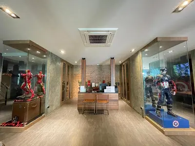 a room with some superhero figurines on display at Loft122 Hotel in Ban Zong Katiam