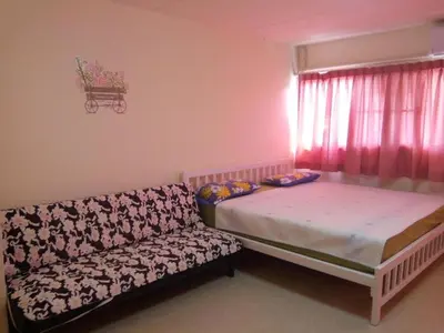 a bedroom with a bed and a couch and a window at Chan Kim Don Mueang Guest House, 550 yards from Impact Muang Thong Thani in Thung Si Kan