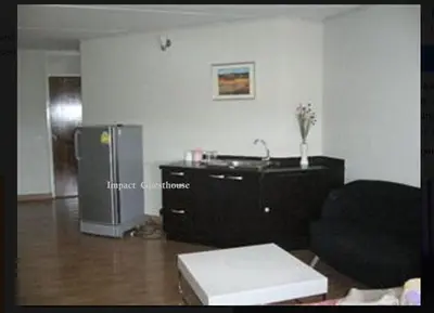 a living room with a couch and a refrigerator at Chan Kim Don Mueang Guest House, 550 yards from Impact Muang Thong Thani in Thung Si Kan