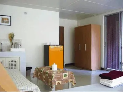 a living room with a table and a cabinet at Poppular Palace Don Mueang Bangkok, 5-minute drive from Impact Arena in Ban Bang Phang