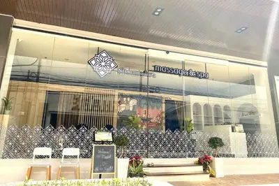 a store front with chairs in front of a building at Nice Residence in heart of Bangkok in Bangkok