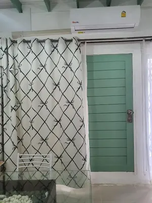 a green garage door with a green garage gate at บ้านอรุณHome in Bangkok