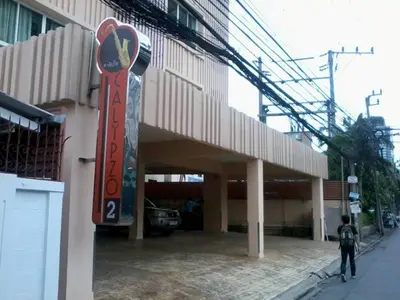 a building with a sign on the side of it at Calypzo 2 Ratchada 20 in Bangkok
