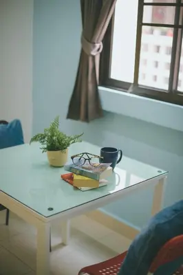 a white coffee table with books and a plant on it at Baan Romdee in Nonthaburi