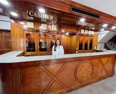 a woman standing at a bar in a restaurant at The Promenade Bangkok in Bangkok