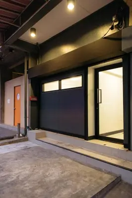 a garage with two sliding glass doors on a building at T3 TWO Bedrooms WIFI Full kitchen 1 min to BTS in Bangkok
