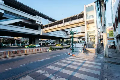 an empty city street with a bridge in the background at T3 TWO Bedrooms WIFI Full kitchen 1 min to BTS in Bangkok