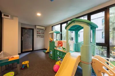 a childs play room with a slide and play equipment at Metro Hotel Ratchada 36 in Bangkok