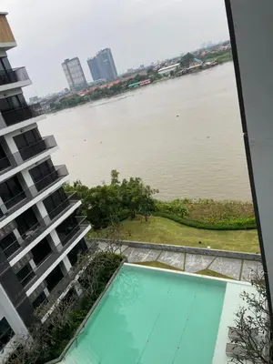a view of the river from the balcony of a building at Politan Breeze, Chaophraya River view in Ban Sai Ma