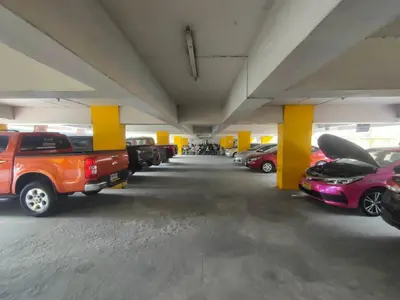 a parking garage filled with lots of parked cars at PRL Place in Bangkok