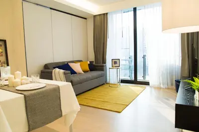 a living room with a couch and a table at Sukhumvit 11#Luxury#Pool#Gym#BTS Nana&MRT Sukhumvit#1BR#Max4ppl in Bangkok