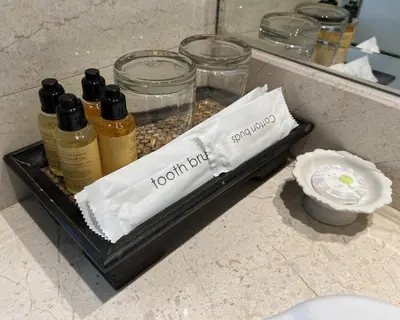 a tray with bottles of liquids on a counter at Silom Forest Exclusive Residence in Bangkok