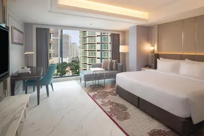 a hotel room with a large bed and a desk at Aira Hotel Bangkok Sukhumvit 11 in Bangkok