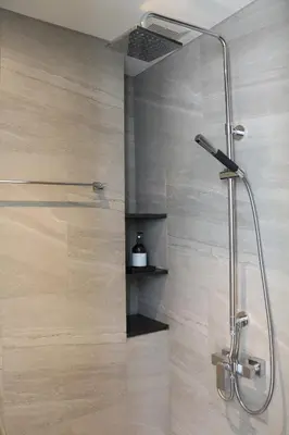 a shower with a glass door in a bathroom at humble abode Bangkok Vacation Home in Bangkok
