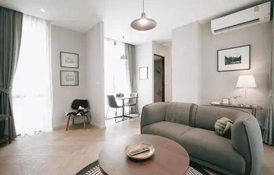 a living room with a couch and a table at humble abode Bangkok Vacation Home in Bangkok