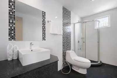 a white bathroom with a sink and a shower at iCheck inn Residences Sathorn in Bangkok