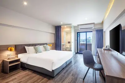 a bedroom with a bed and a desk and a chair at SureStay by Best Western Iconic Ari-Jatujak in Bangkok