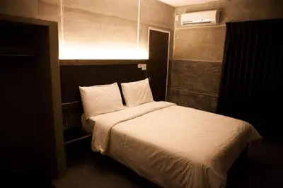 a bedroom with a bed with a light above it at Bangkok 68 in Bangkok