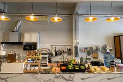 a kitchen with a counter top with some lights at Lemon Siam Hostel Free Breakfast in Bangkok