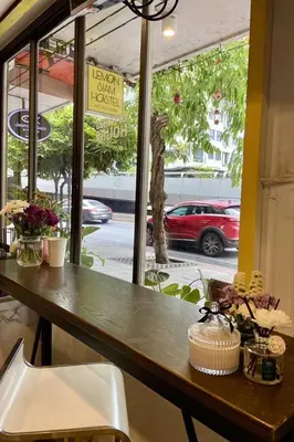 a table in a restaurant with a view of a street at Lemon Siam Hostel Free Breakfast in Bangkok