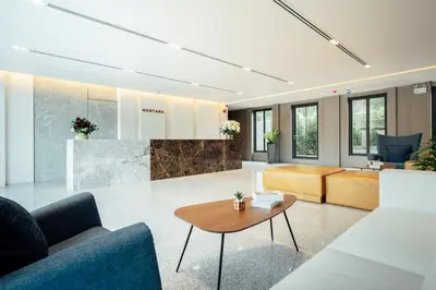 a living room with couches and a table at Montana Bangkok Hotel & Residence in Bangkok