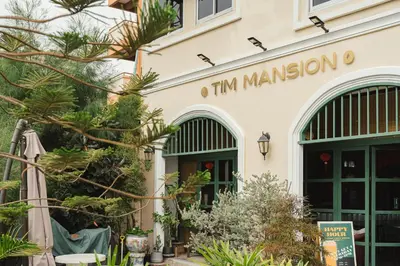 a building with a sign that reads im mansion at Tim Mansion in Bangkok