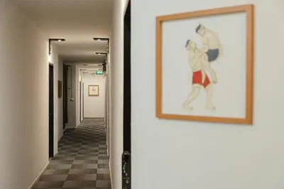 a hallway with a painting on the wall at Tim Mansion in Bangkok