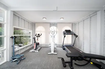 a gym with a treadmill and several exercise equipment at The Riski Hotel at Bangphlat Station SHA in Bangkok