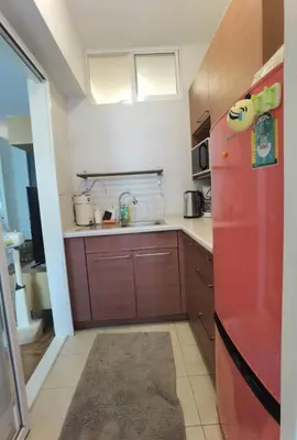 a kitchen with a red refrigerator and a sink at Rama9 Cozy Apartment in Bangkok