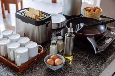 a kitchen counter with eggs and a pan and a tray of food at Siamaze Hostel in Bangkok