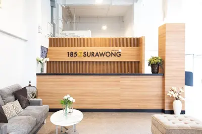 a lobby with a sign that reads swinging at 185@Surawong Residence in Bangkok