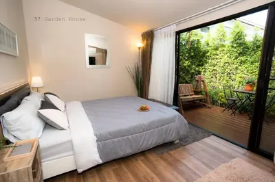 a bedroom with a bed and a balcony at 37 Nature House in Bangkok