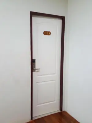a white door with a sign on it at Bangkok Check Inn @Chareon Krung in Bangkok