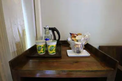 a table with two cups and a coffee maker on it at Platinum Place in Bangkok