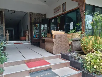 a store front with a bunch of plants at Platinum Place in Bangkok