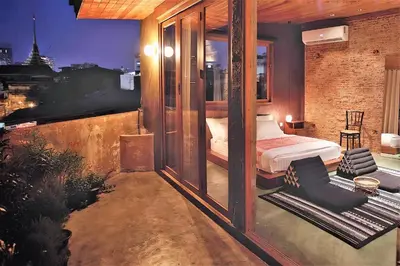 a bedroom with a bed on a balcony at Ba Hao Residence in Bangkok
