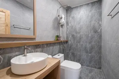 a bathroom with a sink and a toilet at COROOM BKK in Bangkok