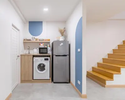 a kitchen with a refrigerator and a washing machine at COROOM BKK in Bangkok