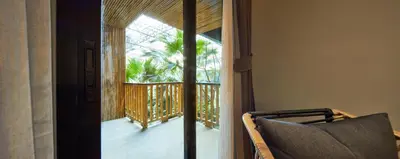 a room with a door leading to a balcony at 515 VICTORY Hotel in Pom Prap