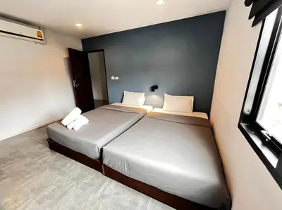 a bedroom with two beds and a window at WiRE BANGKOK PRAKHANONG in Amphoe Phra Khanong
