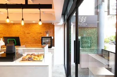 a bakery with a counter with pastries on it at WiRE BANGKOK PRAKHANONG in Amphoe Phra Khanong