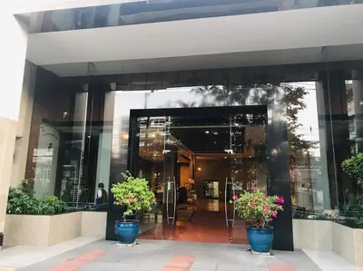 a building with three potted plants in front of it at Harmony family room in Bangkok