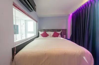 a bedroom with a large white bed with pink pillows at Spark Hotel - MRT Queen Sirikit - SHA Extra Plus Certified in Bangkok