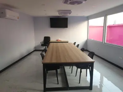 a conference room with a wooden table and chairs at Spark Hotel - MRT Queen Sirikit - SHA Extra Plus Certified in Bangkok