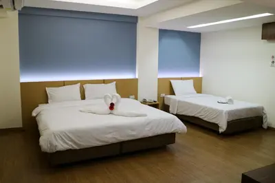 a room with two beds with a stuffed bunny on them at Beerapan Hotel in Bangkok