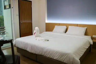 a bedroom with a bed with a shark head on it at Beerapan Hotel in Bangkok
